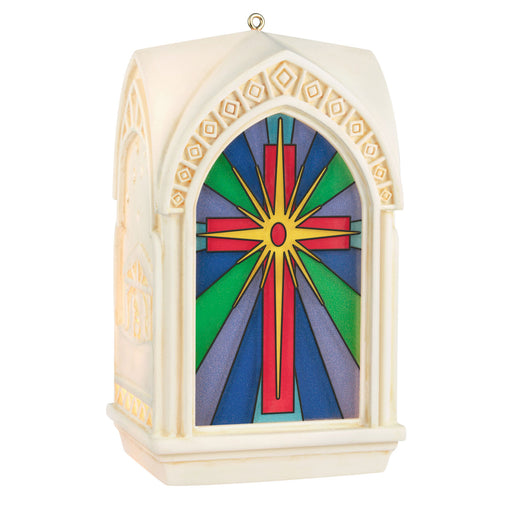 Decorative ornament with stained glass design featuring a cross on a white background