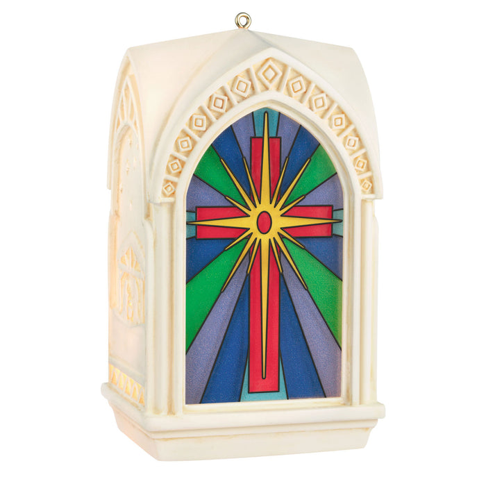 Decorative ornament with stained glass design featuring a cross on a white background