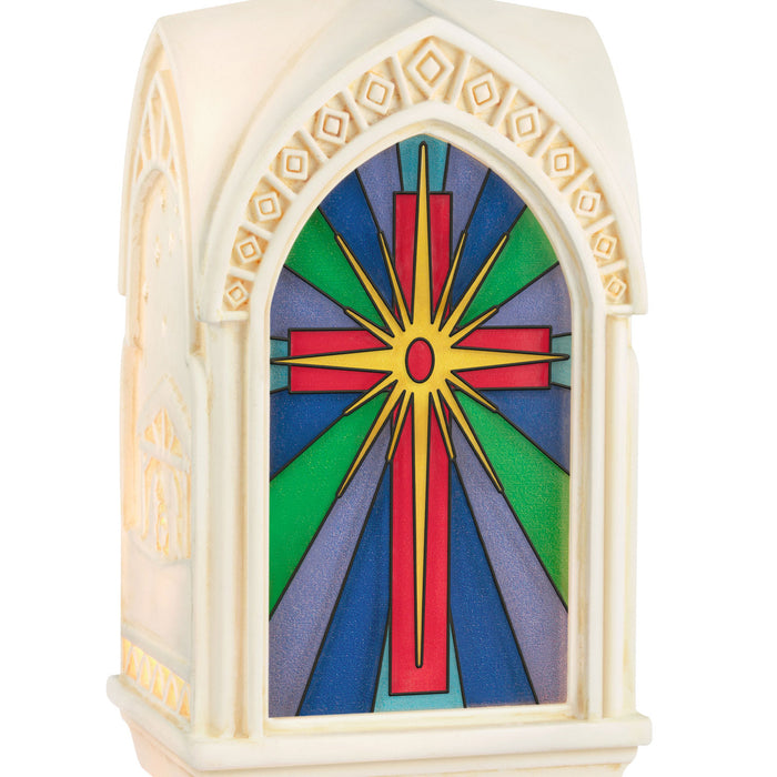 Decorative ornament with stained glass design featuring a cross on a white background