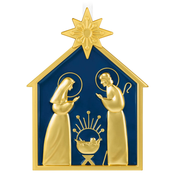 Decorative nativity scene ornament with gold figures and blue background