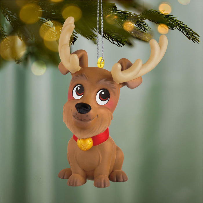 Dog reindeer ornament with a red collar and gold tag, hanging from a Christmas tree.