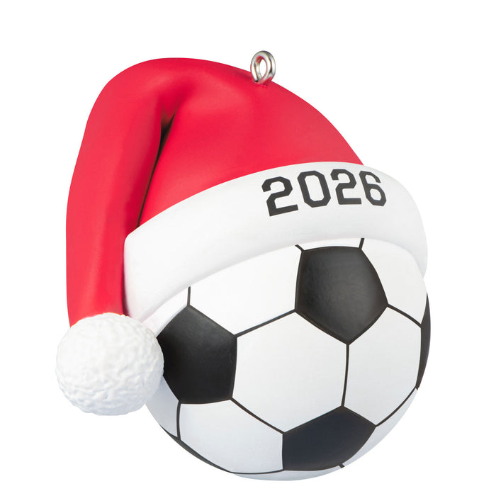 Soccer ball with a Santa hat and '2026' on a white background