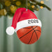 Basketball ornament with Santa hat and '2026' on a Christmas tree.