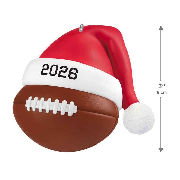Football ornament with a Santa hat labeled '2026' on a white background