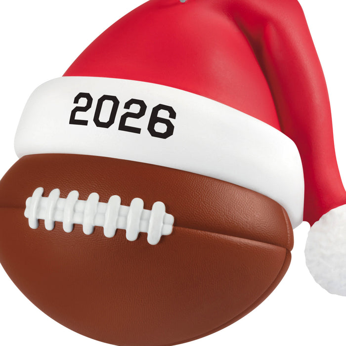 Football with a Santa hat and '2026' band on a white background
