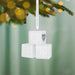 White baby blocks ornament with 'A B C' and '2026' on a Christmas tree with blurred lights in the background.