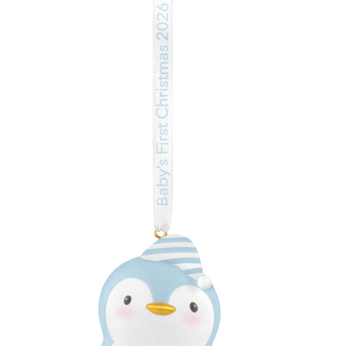 Decorative penguin ornament with 'Baby's First Christmas 2026' text on a white background