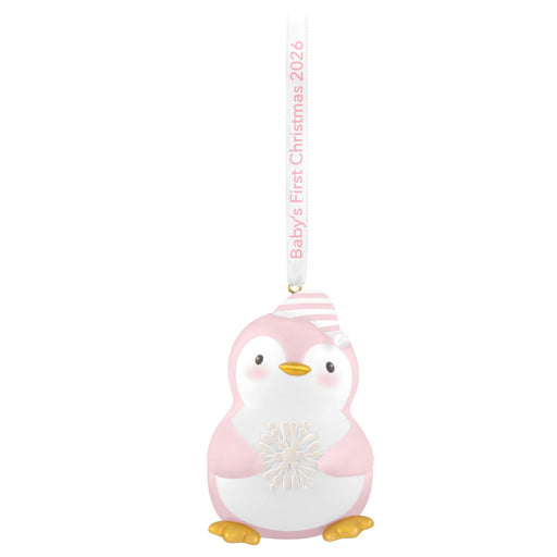 Pink penguin ornament with 'Baby's First Christmas 2026' text on a white background