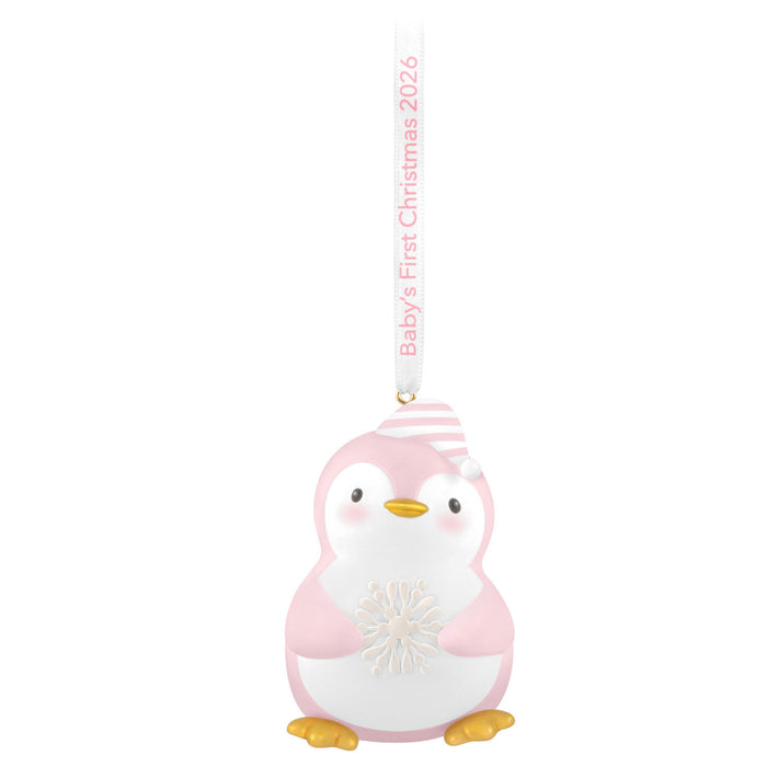 Pink penguin ornament with 'Baby's First Christmas 2026' text on a white background