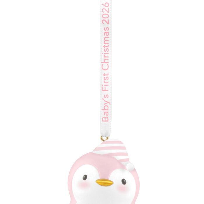 Penguin ornament with pink striped hat featuring 'Baby's First Christmas 2026' text.