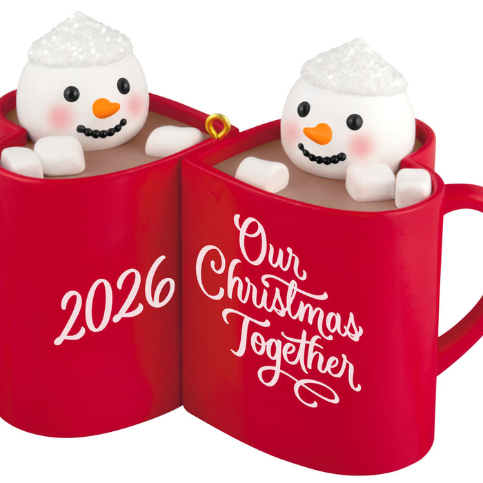 Two red mugs with snowman figures inside, displaying '2026' and 'Our Christmas Together'.