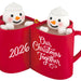 Two red mugs with snowman figures inside, displaying '2026' and 'Our Christmas Together'.