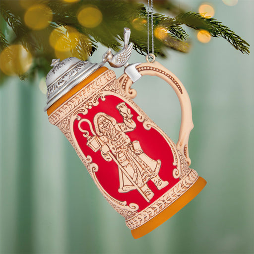Decorative beer stein ornament hanging on a Christmas tree.