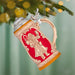 Decorative beer stein ornament hanging on a Christmas tree.