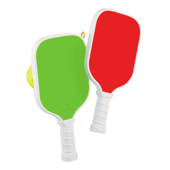 Two pickleball paddles, one green and one red, on a white background.