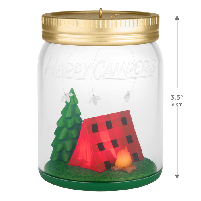 Decorative jar with a gold lid, 'Happy Campers' text, and camping scene inside.
