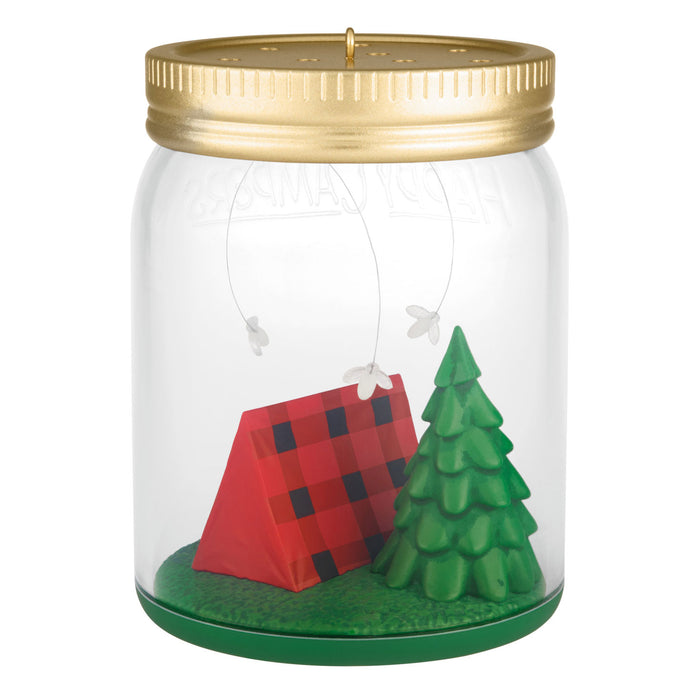 Decorative jar with a red cabin and green tree inside, on a white background