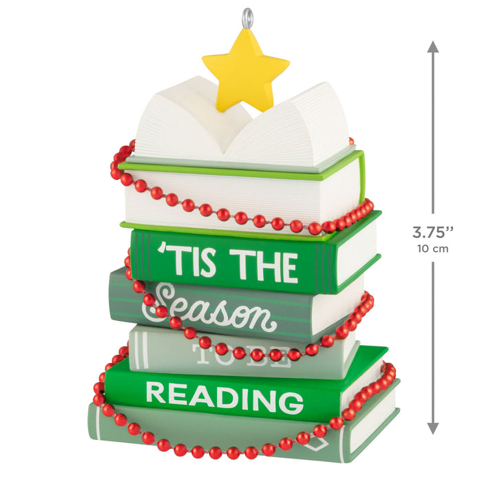 Stack of books with decorative beads and a star on top, featuring text 'Tis the Season to be Reading'.