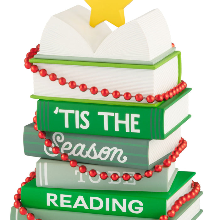 Decorative book stack ornament with 'Tis the Season to be Reading text and red beads on a white background