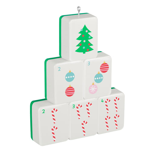 Stack of Christmas-themed dice with tree, ornaments, and candy cane designs on a white background.