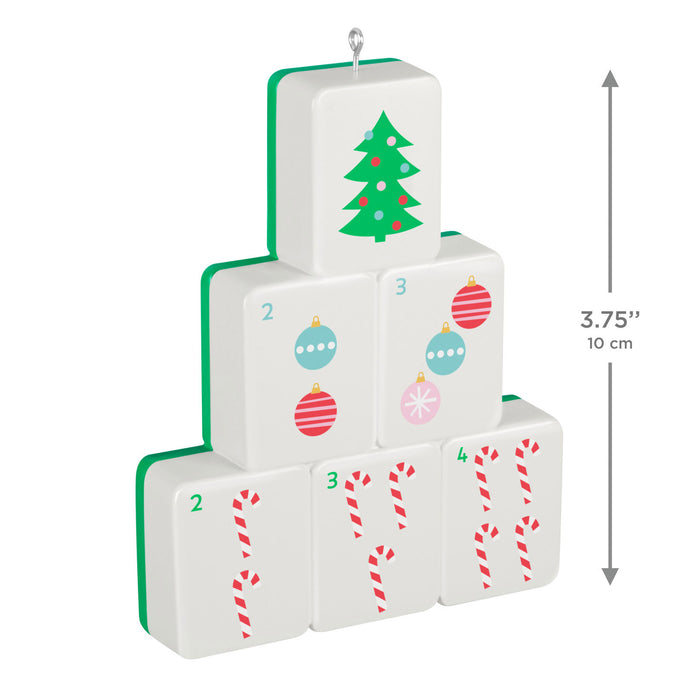 Stack of Christmas-themed dice with tree, ball, and candy cane designs on a white background.