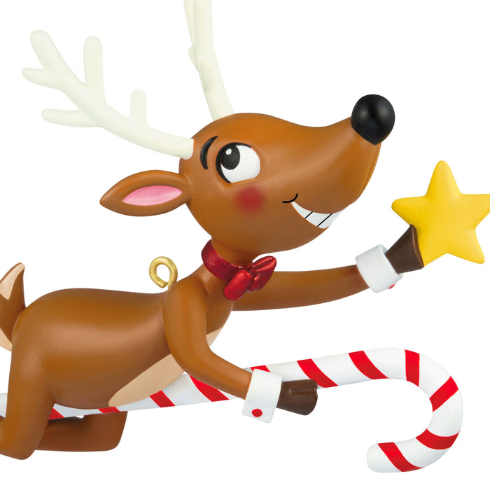 Animated reindeer character with a candy cane and star on a white background