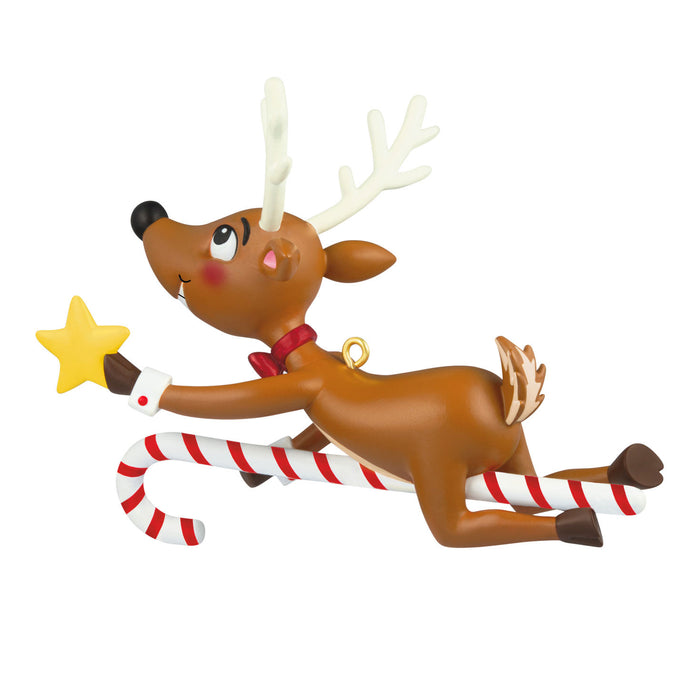 Decorative reindeer figurine with candy cane and star on a white background
