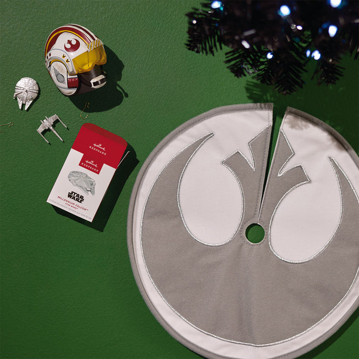 Star Wars-themed tree skirt with decorative items on a green surface