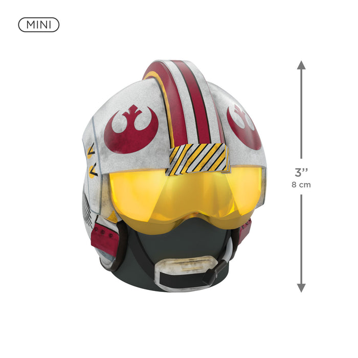 Miniature helmet with a red and white design, resembling a Star Wars character, on a white background.