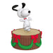Animated character on a wooden barrel with red bows and green garland