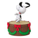 Snoopy figurine on a decorated barrel with red bows and green garlands on a white background