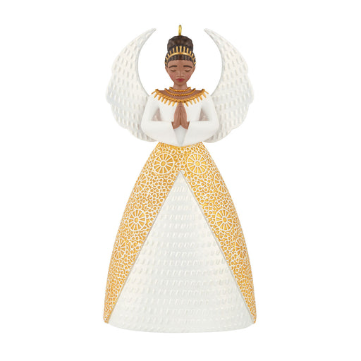Decorative angel ornament with gold and white dress on a white background