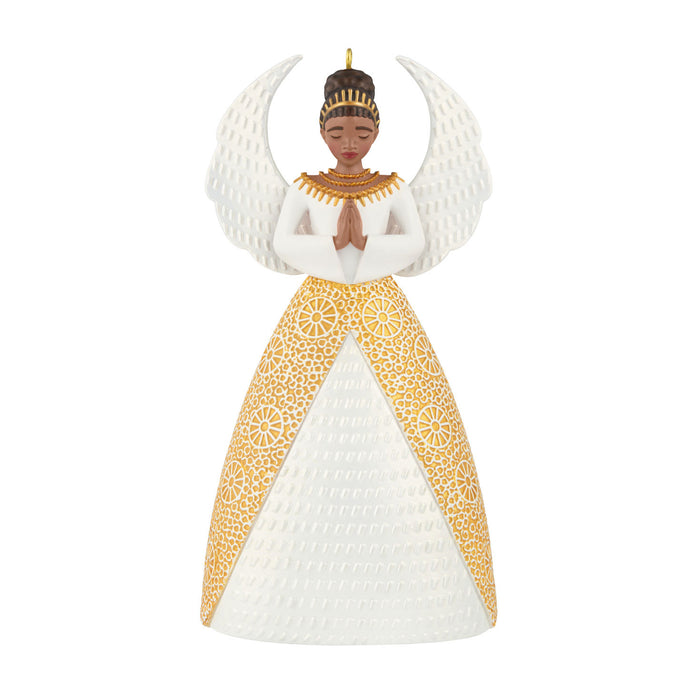 Decorative angel ornament with gold and white dress on a white background