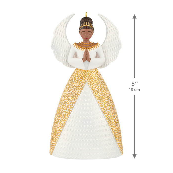 Decorative angel ornament with gold and white dress, measurement label on a white background