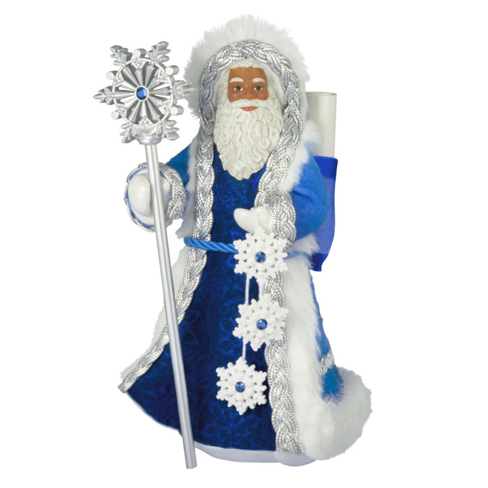 Decorative figure of a bearded man in blue robes with a silver staff on a white background