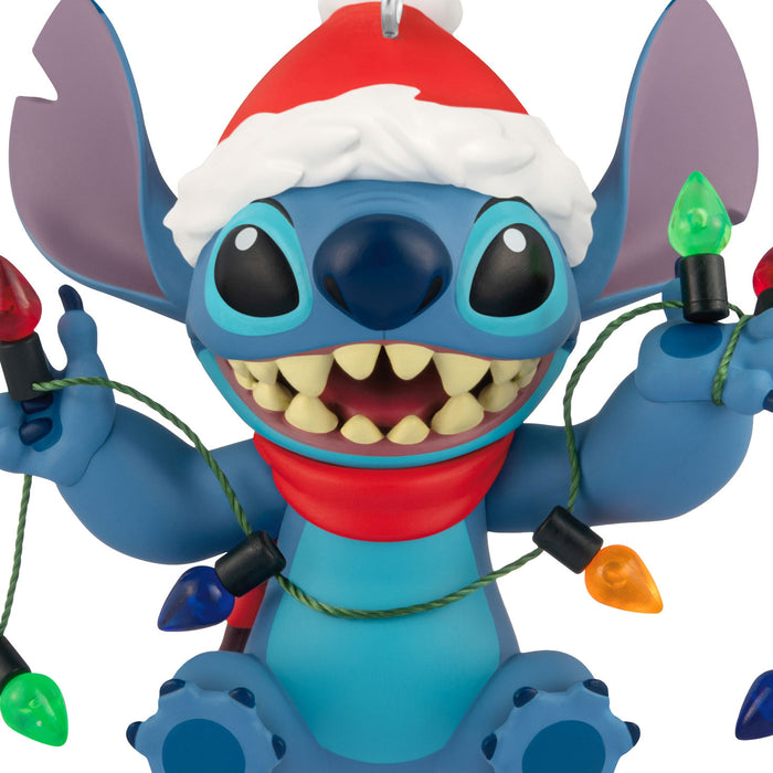 Blue cartoon character wearing a Santa hat with Christmas lights.