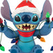 Blue cartoon character wearing a Santa hat with Christmas lights.