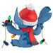 Blue cartoon character with a Santa hat and scarf holding Christmas lights on a white background