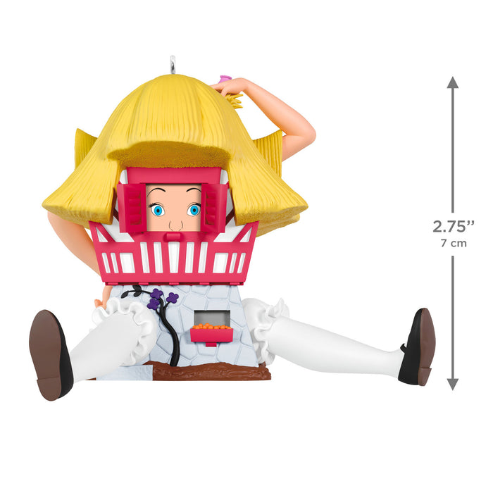 Toy figure with yellow hair and pink headgear on a white background