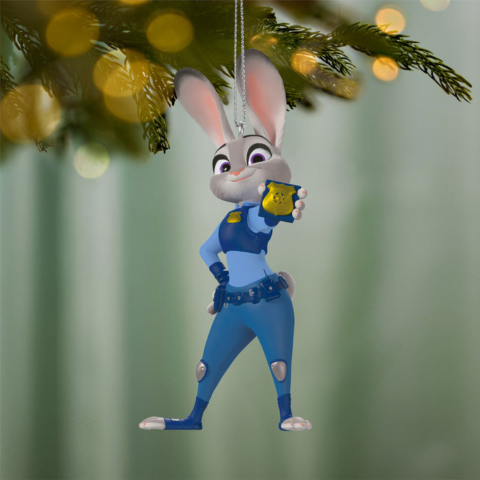 Decorative Christmas ornament of a rabbit character in a blue uniform hanging on a tree.