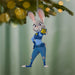 Decorative Christmas ornament of a rabbit character in a blue uniform hanging on a tree.