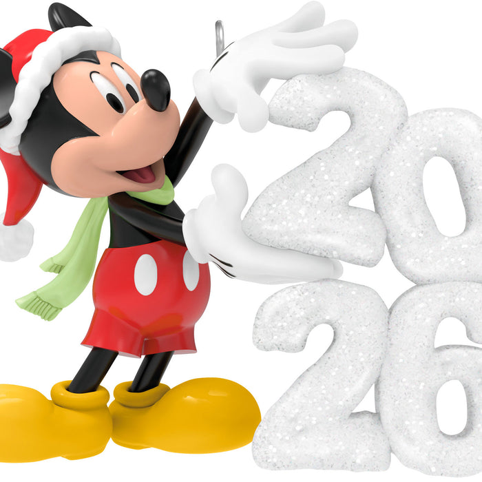 Mickey Mouse Christmas ornament with a Santa hat and scarf, next to snowflake decorations spelling '2020'.