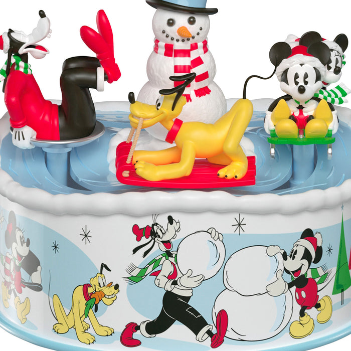 Animated scene with cartoon characters around a snowman, featuring Goofy, Pluto, and Mickey Mouse.
