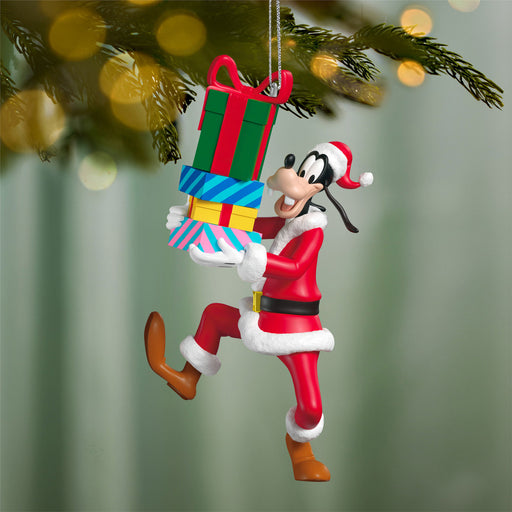 Christmas ornament of a character holding colorful presents against a blurred green background