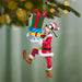 Christmas ornament of a character holding colorful presents against a blurred green background