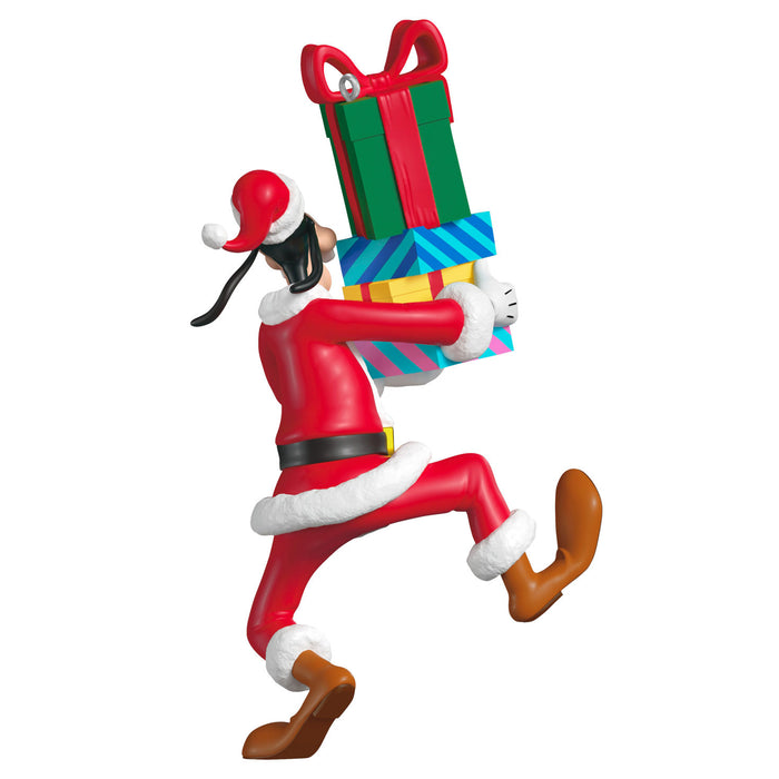 Elf figurine carrying Christmas presents on a white background