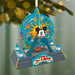 Decorative Christmas ornament resembling a Ferris wheel with Mickey Mouse face, hanging on a tree.