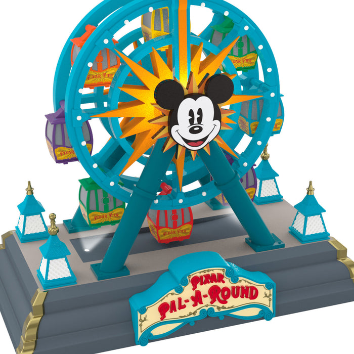 Model of a Ferris wheel with a character design in front, featuring the 'Pixar Pal-A-Round' logo.