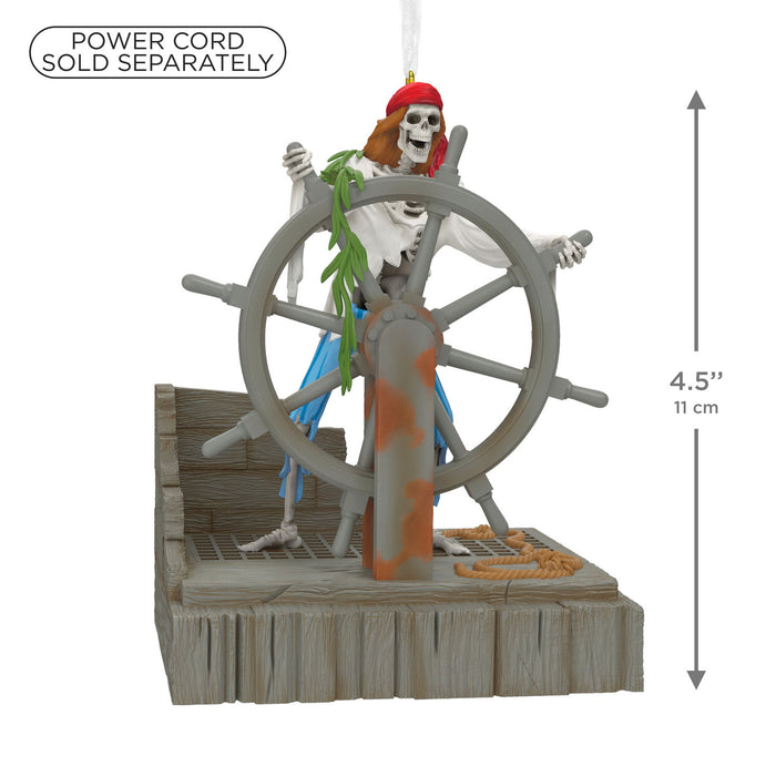 Decorative ornament of a skeleton pirate on a ship's wheel with dimensions indicated.