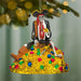 Pirate skeleton ornament on a gold treasure chest with colorful gems, hanging from a tree.
